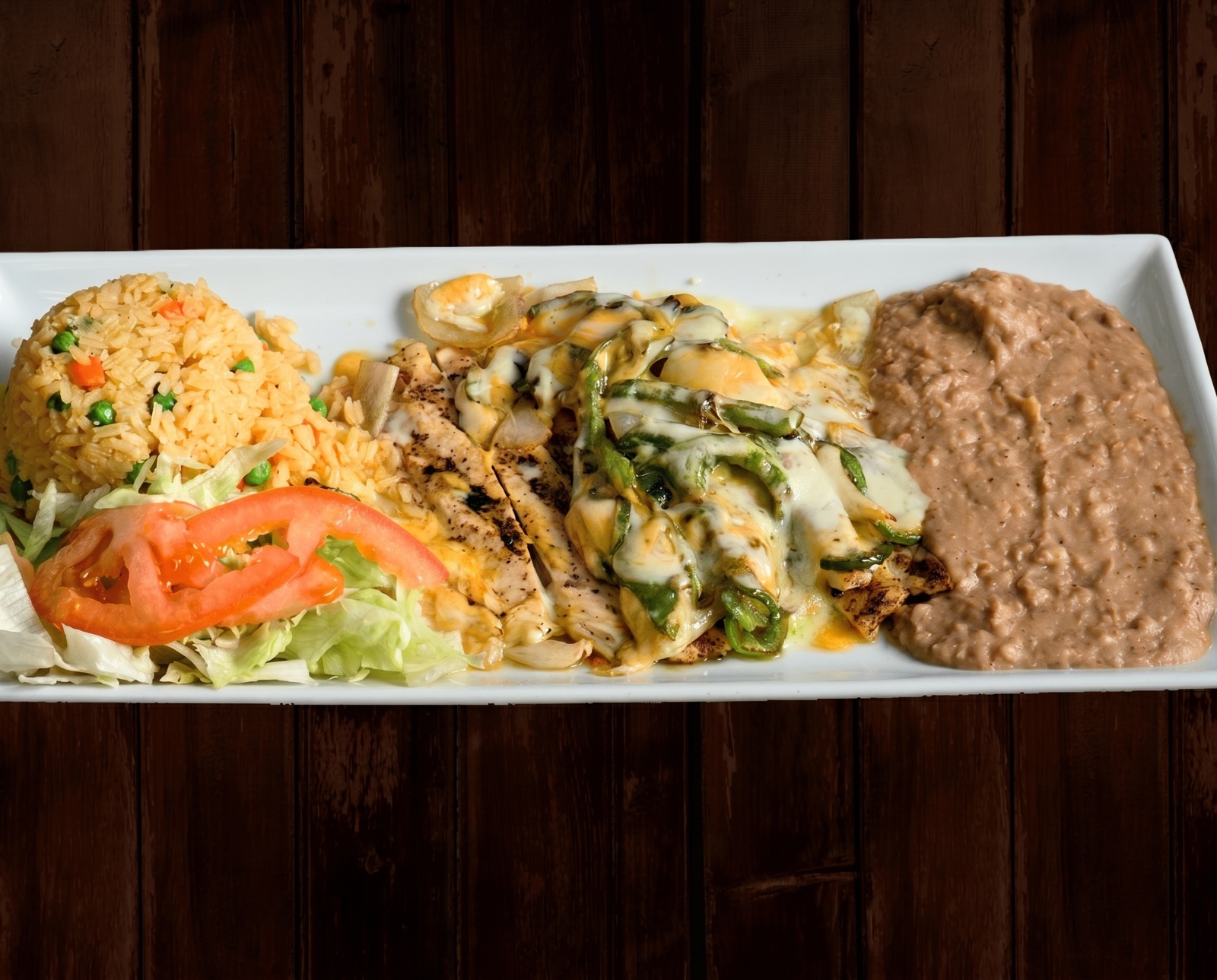 Breaded fried shrimp served with rice, beans and fresh salad